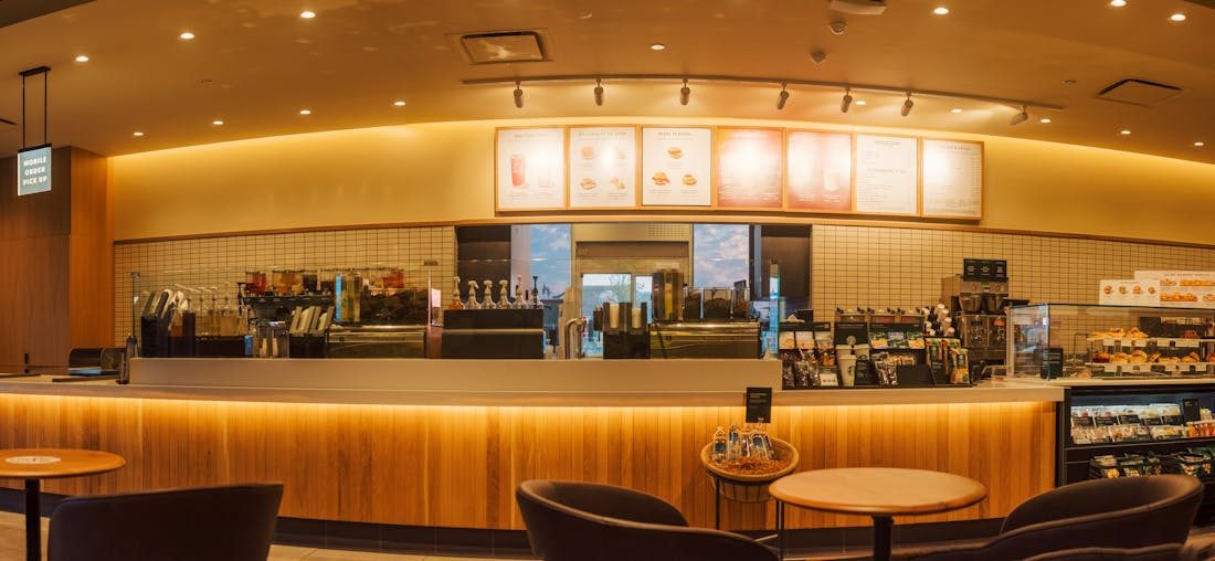 Warm-lit coffee shop interior with wooden counter